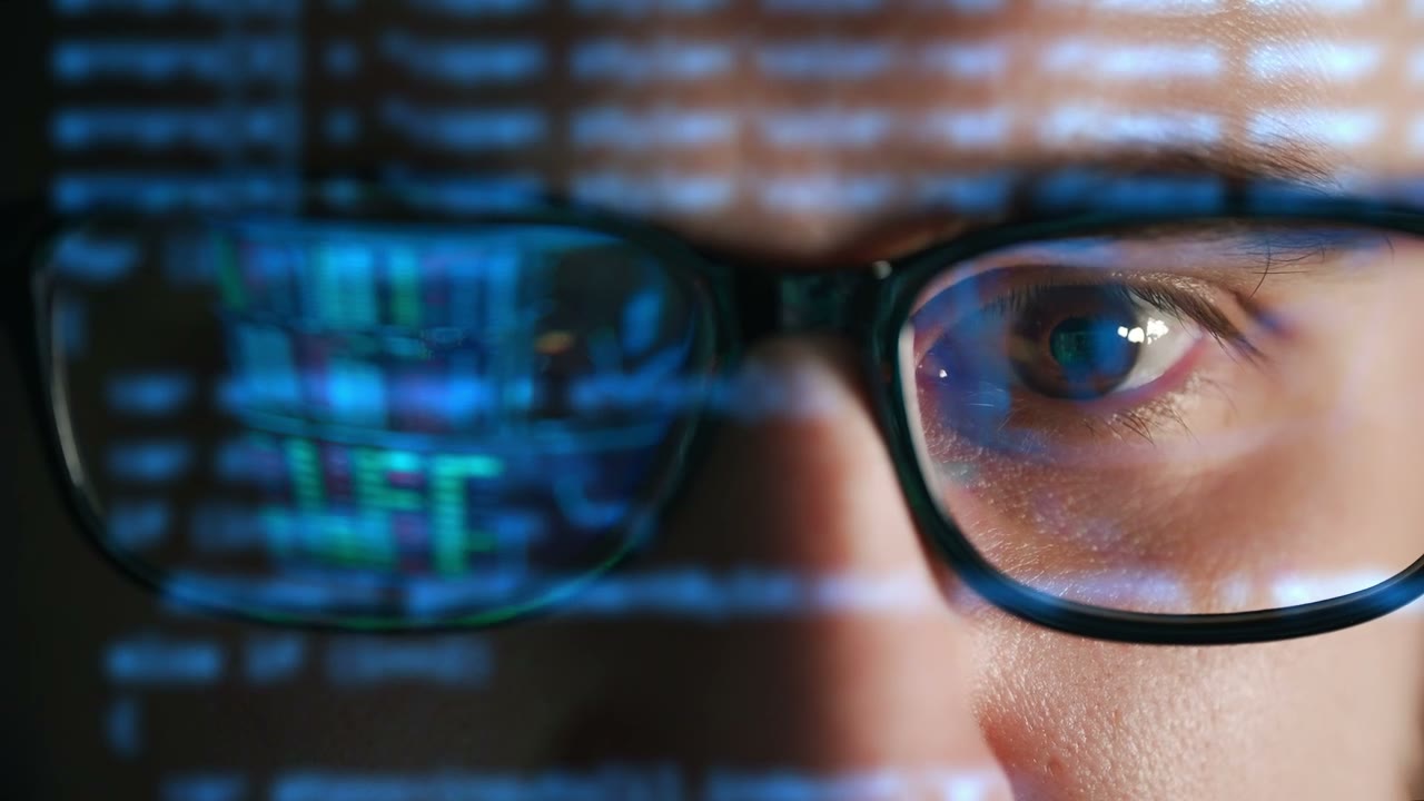 Software developer writing code on screen